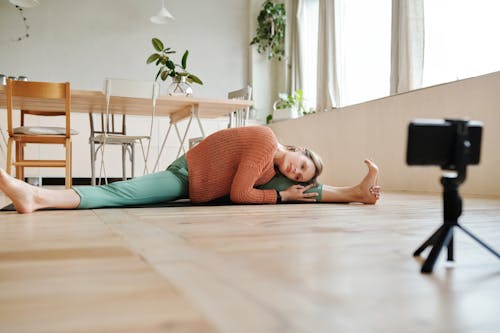 Woman in Brown Sweater and Green Leggings Doing Yoga