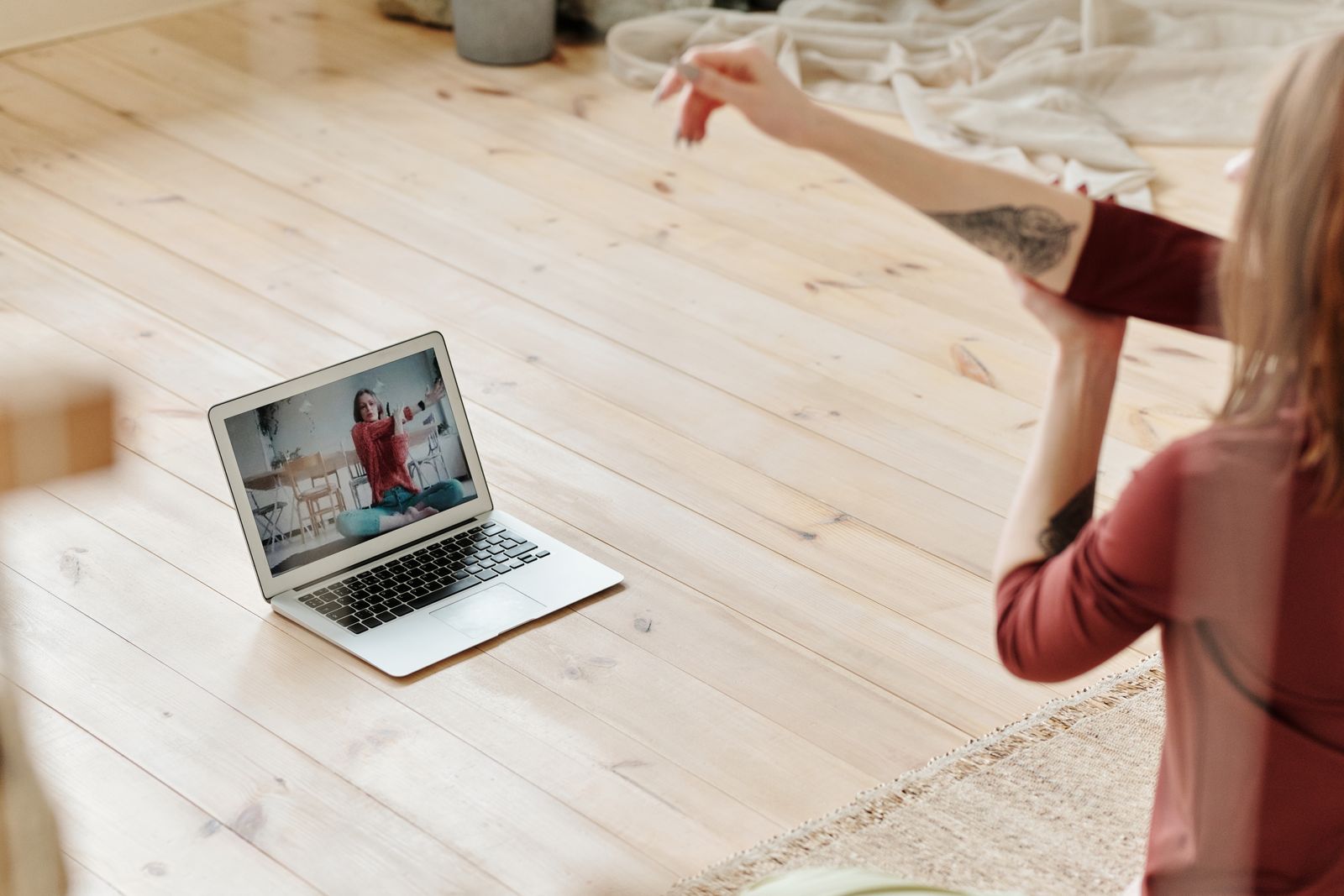 Person browsing an online fitness class on a laptop before choosing an instructor