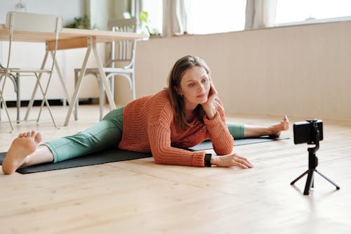 A Woman Doing Yoga Near the Window on the Floor 