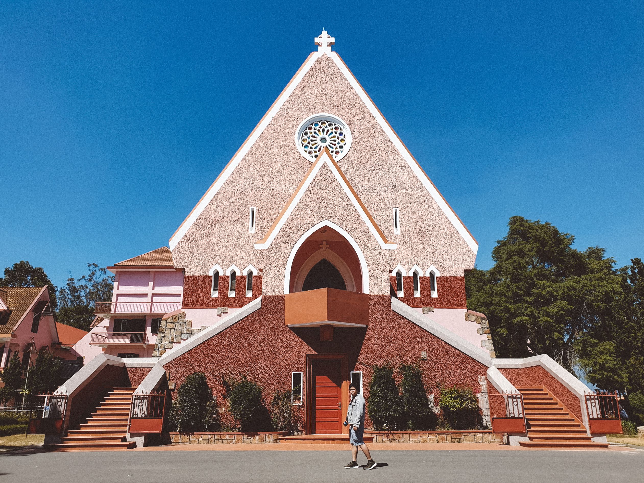 modern church building exterior with families walking in Ho Ghana