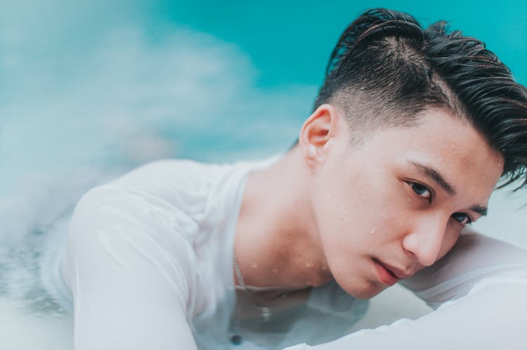 A Man In White Shirt In The Pool