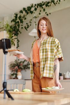 Woman cooking avocado toast in a stylish kitchen, perfect for lifestyle and culinary themes.