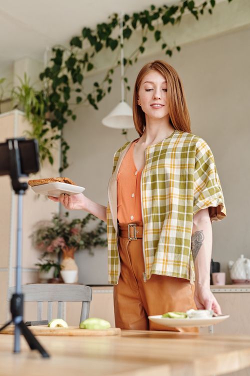 Free Woman cooking avocado toast in a stylish kitchen, perfect for lifestyle and culinary themes. Stock Photo