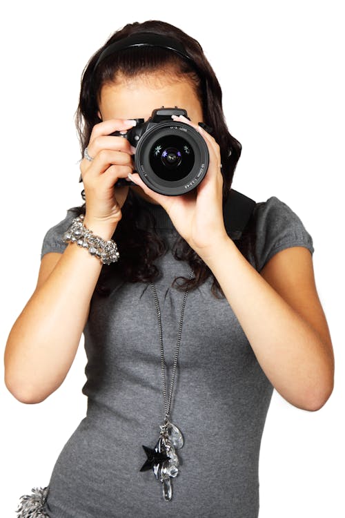 Free Woman in Grey T-Shirt Using Black DSLR Camera Stock Photo