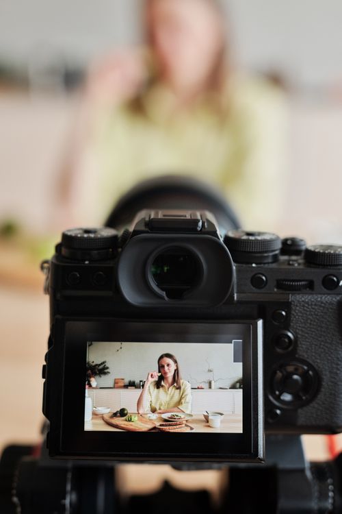 content creator filming video with professional camera equipment