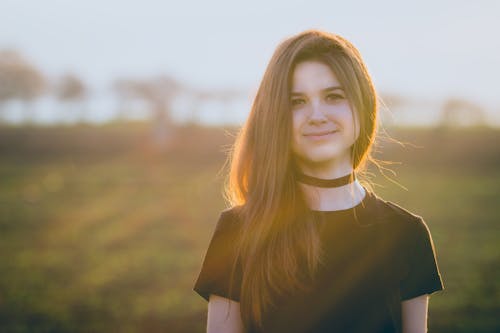 Woman Wearing Black Crew-neck T-shirt and Black Choker Necklace