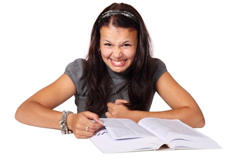 Woman in Gray Puff Sleeve Turtleneck Shirt Sitting at the Table Scanning Book