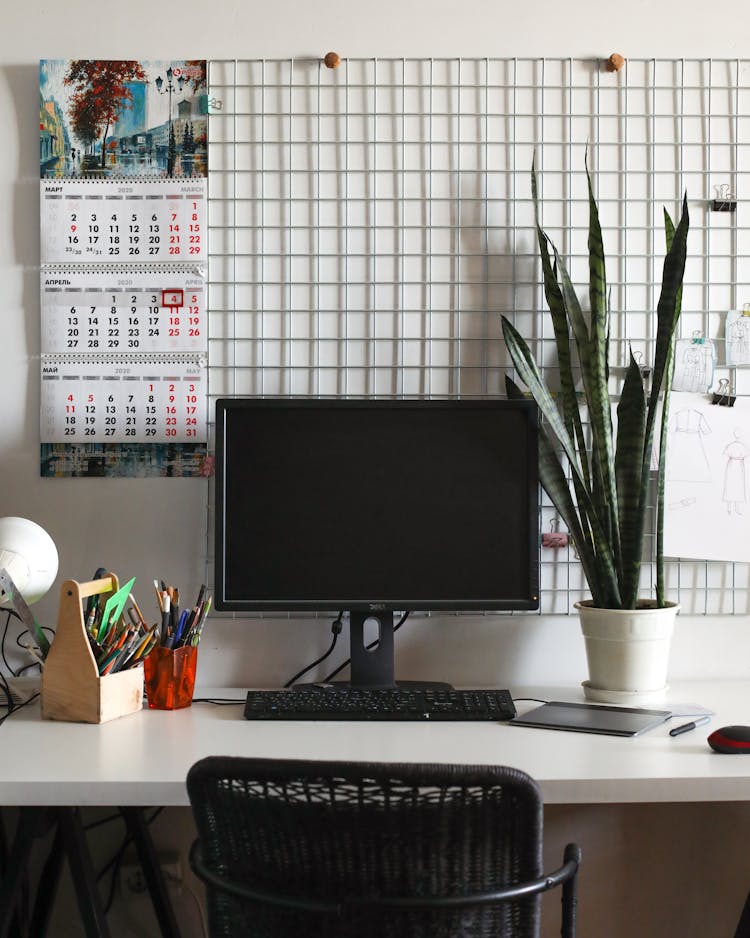 Contemporary Style Workplace With Desktop Computer And Calendar On Wall