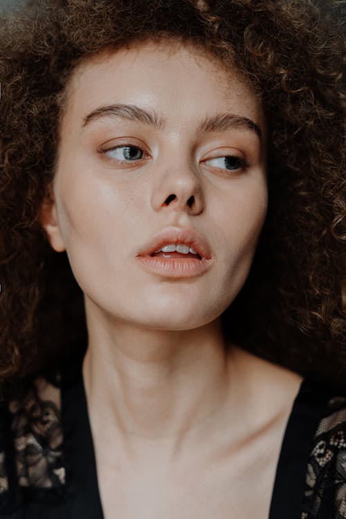 Portrait Photo of Woman with Brown Curly Hair