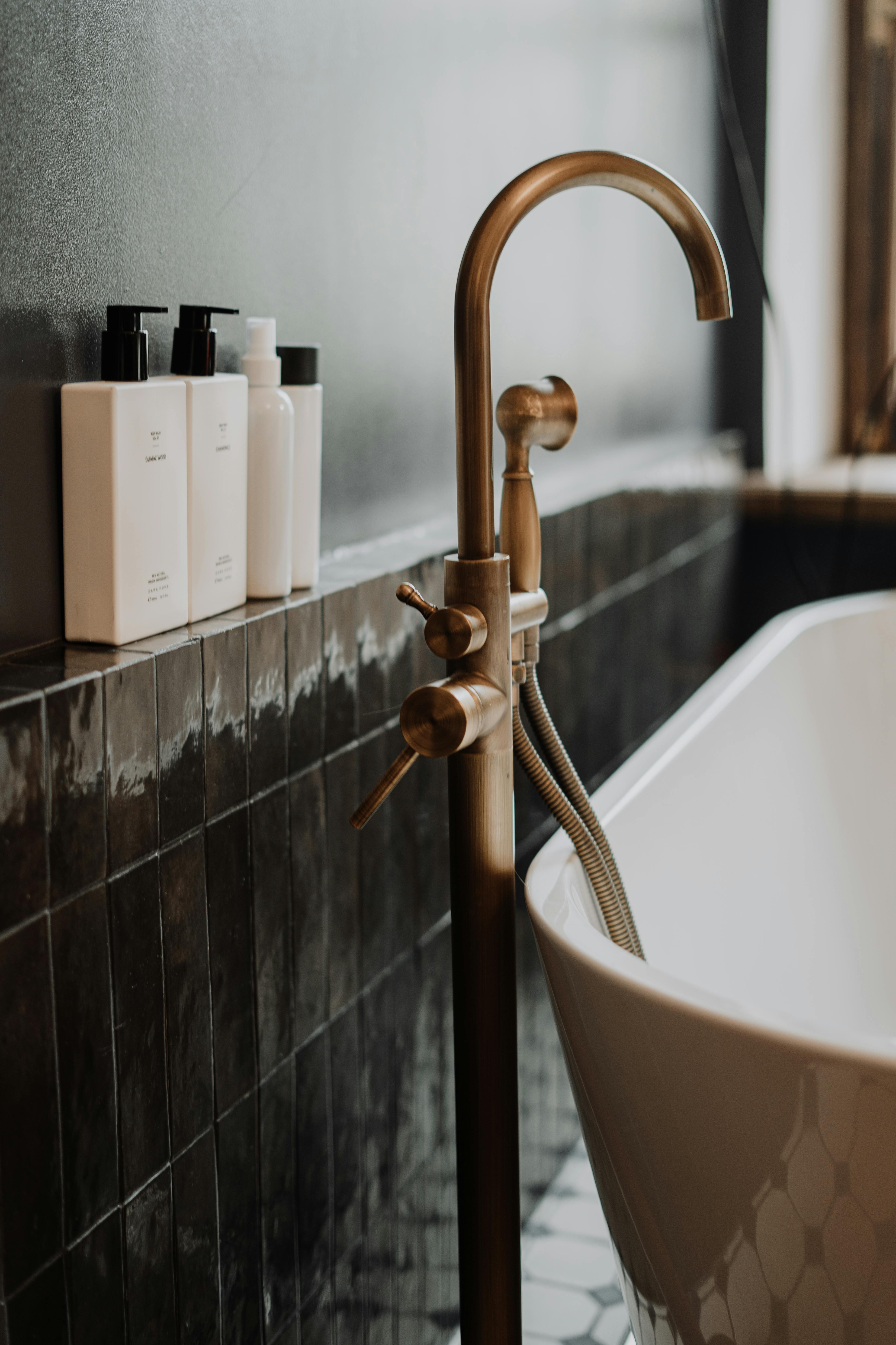 stainless steel faucet on bathtub