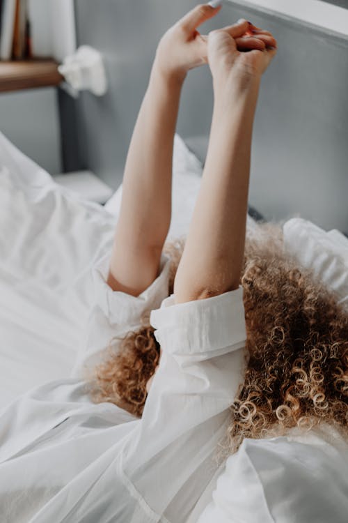 Free Woman in White Dress Lying on Bed Stock Photo