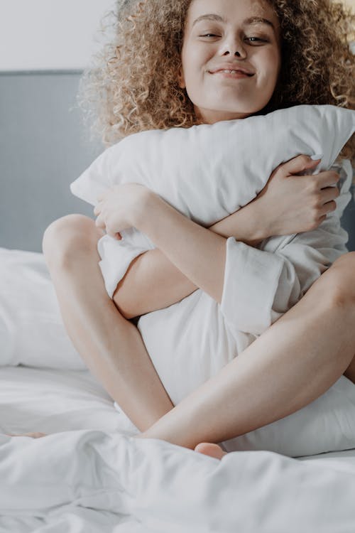 Free Woman in White Dress Lying on Bed Stock Photo