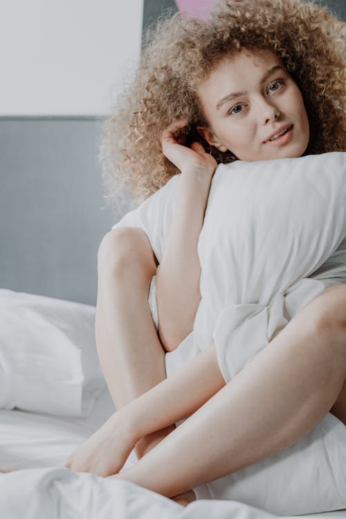 Free Woman in White Dress Lying on Bed Stock Photo