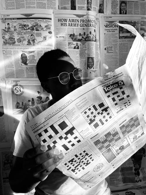 Free Person Wearing Metal Framed Eyeglasses Reading a Newspaper  Stock Photo