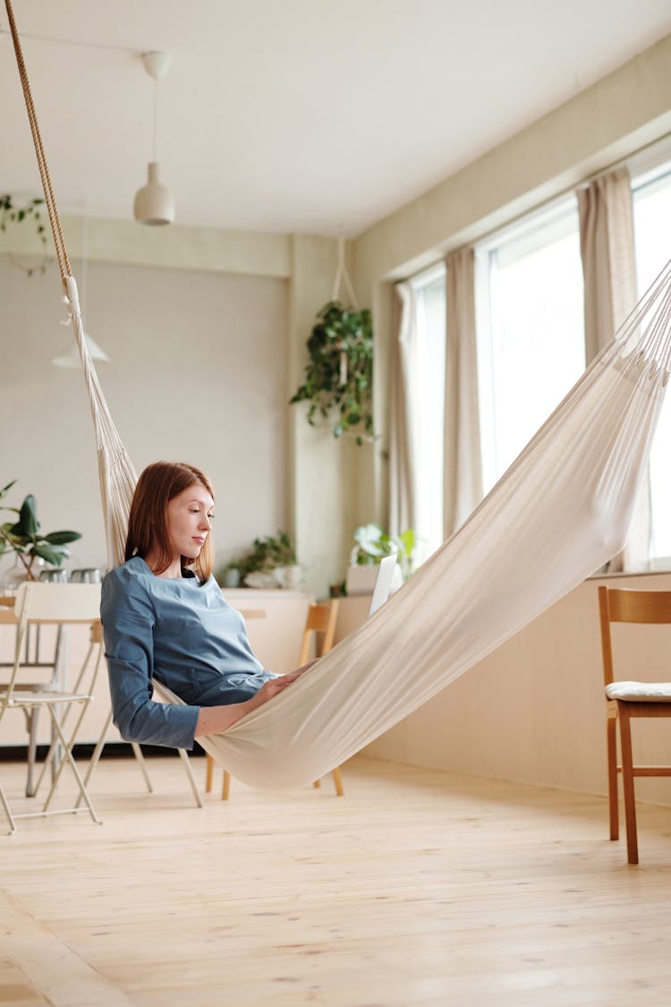 A Woman Sitting On A Hammock 