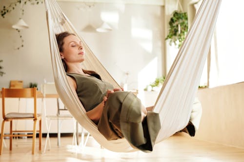 Free Photo of a Woman Closing Her Eyes on a Hammock Stock Photo