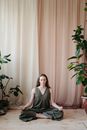 Woman in Gray Sleeveless Dress Standing Beside Green Plant