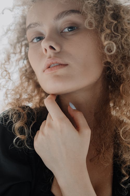 Woman in Black Shirt Holding Her Face