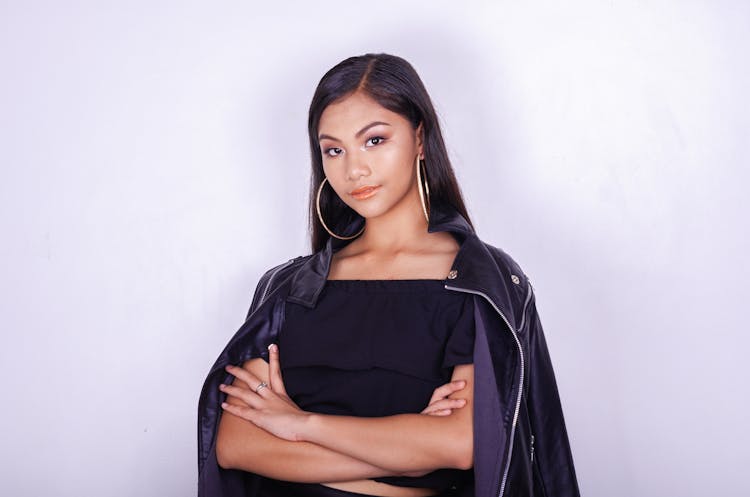 Trendy Young Ethnic Lady With Crossed Arms In Studio