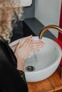 Person Washing Hand on Sink