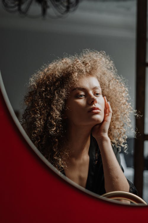 Woman in Black Shirt Holding Her Face