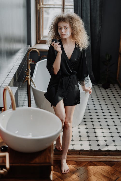 Woman in Black Dress Standing on Gray Concrete Floor