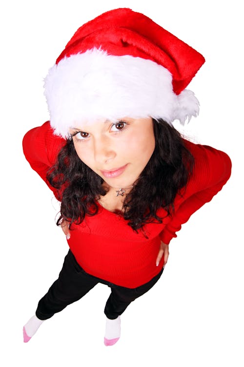 Woman Standing Wearing Red Scoop Neck Long Sleeve Shirt and Santa Cap