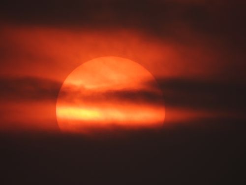 Free A vivid sunset with dark clouds obscuring the sun over Hyderabad, India. Stock Photo