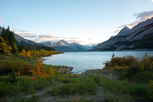 Beautiful autumn landscape of a lake and mountains in Alberta, Canada at sunset.