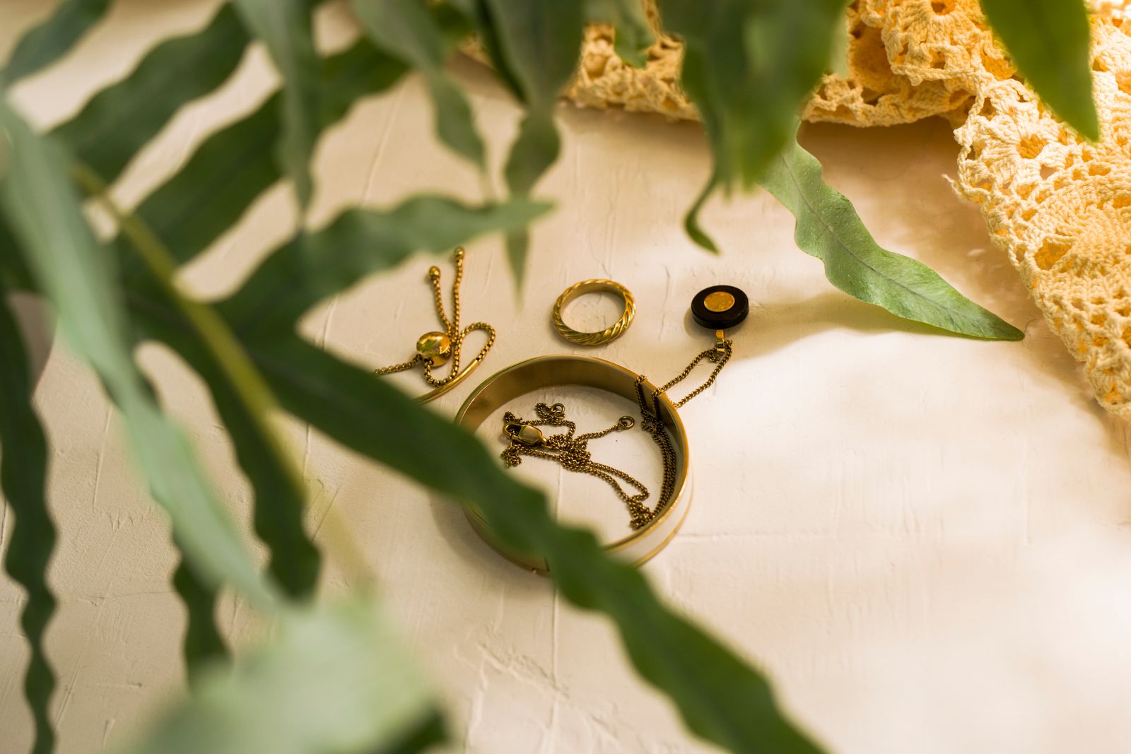 Gold jewelry flat lay on white surface