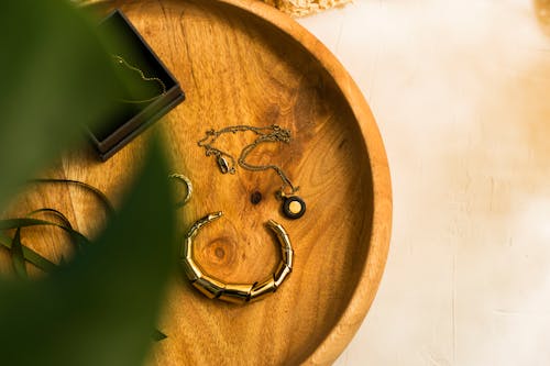 A Bracelet and a Necklace on a Wooden Tray