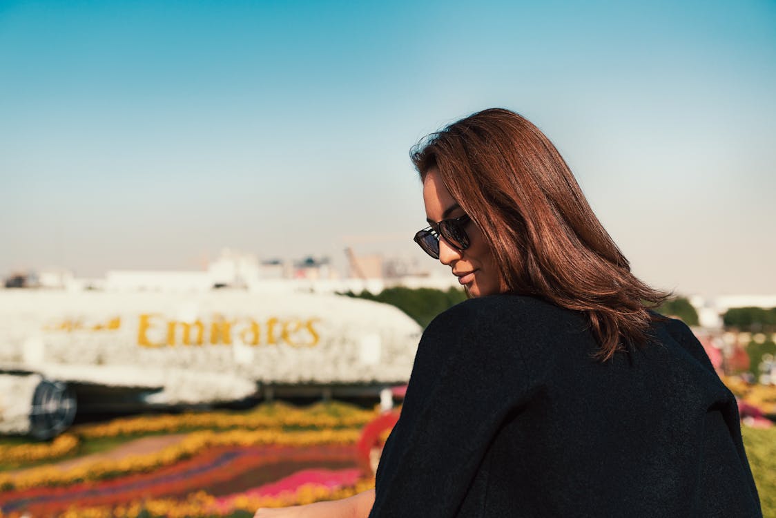 Woman in Black Long Sleeve Shirt Wearing Black Sunglasses