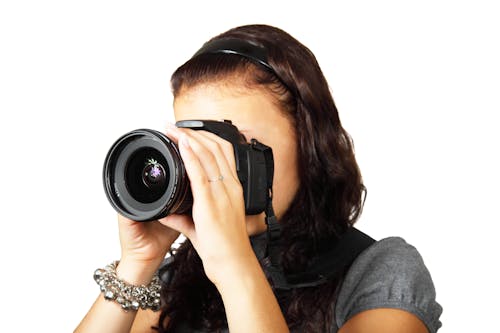 Woman in Grey Shirt Taking Picture With Dslr Camera