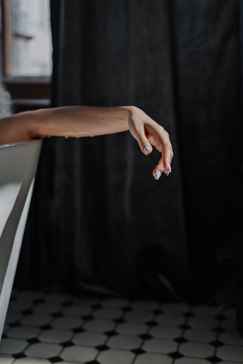 Persons Hand on White Table