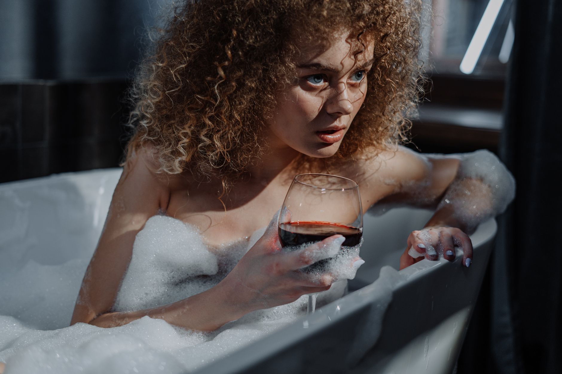 Woman preparing an ice bath with ice cubes and water.