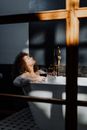 女士在沐浴中享受泡沫和葡萄酒，拥抱放松