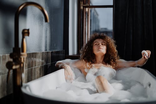 Free Woman in Bathtub With Water Stock Photo