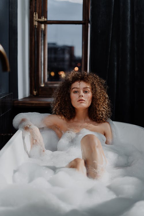 Topless Woman in Bathtub With Water