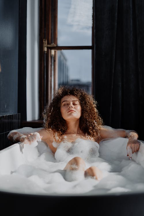 Free Woman in Bathtub With Water Stock Photo