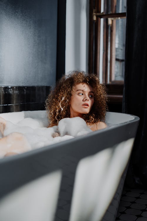 Free Woman in Bathtub With Bubbles Stock Photo