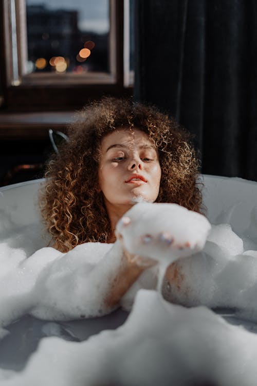 Free Woman in Brown Shirt Lying on White Snow Stock Photo