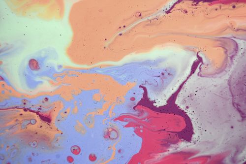 Free Abstract wallpaper with multicolored spilled mixed paints including pink blue and beige on smooth surface Stock Photo