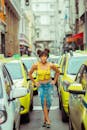 Positive black woman making fish face on road between cars