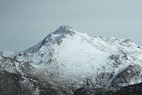 Dramatic view of majestic mountain summit under snow