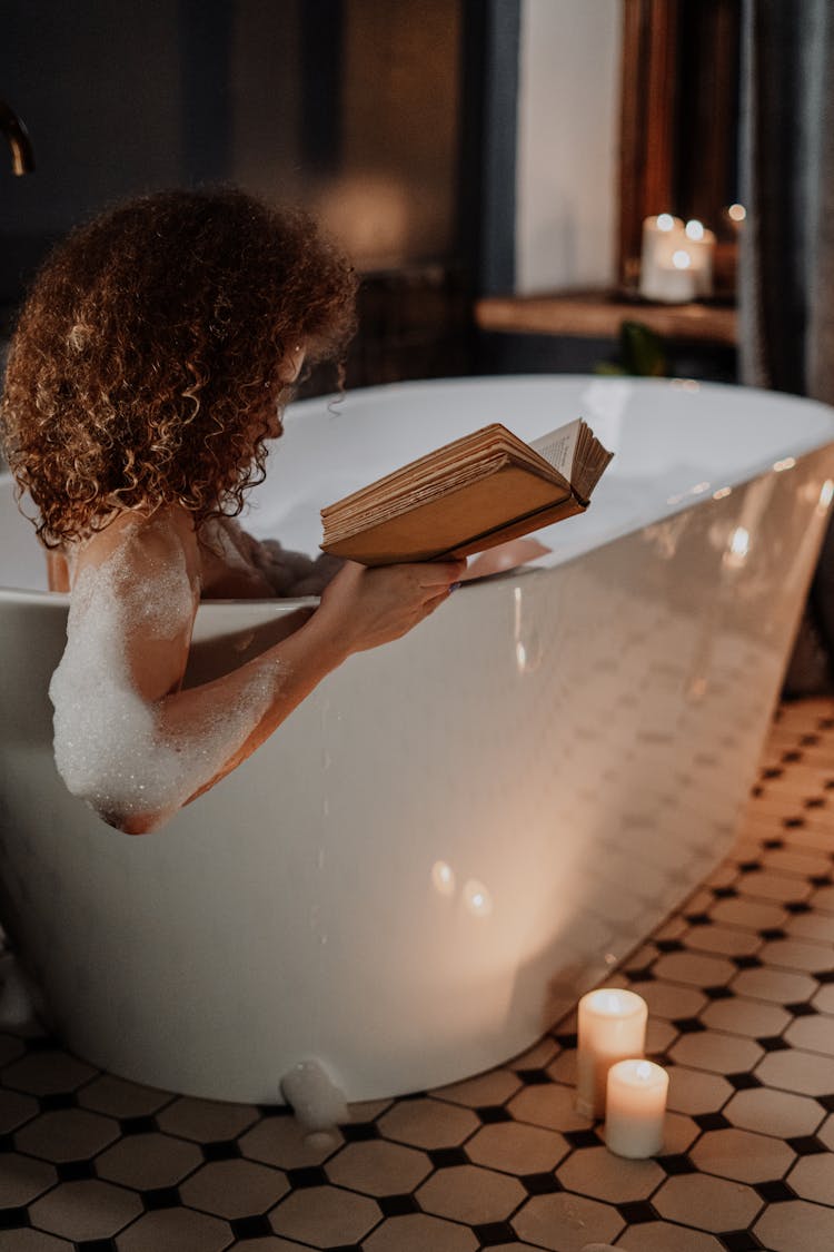 Woman In White Bath Tub Reading Book