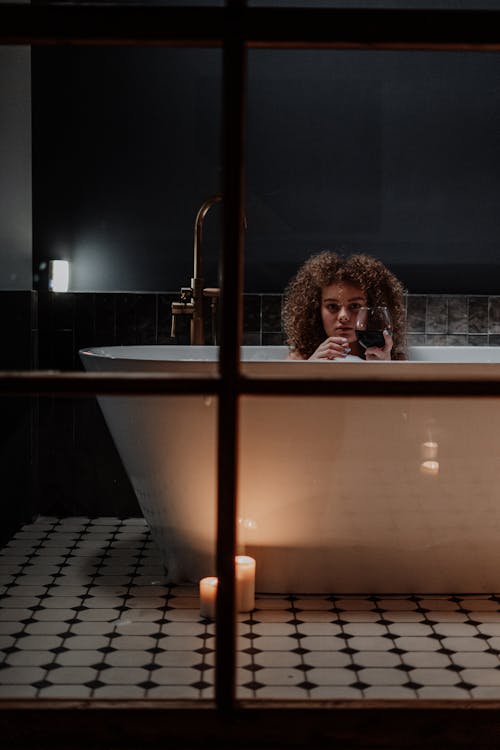 Free Woman in Bathtub With Stainless Steel Railings Stock Photo