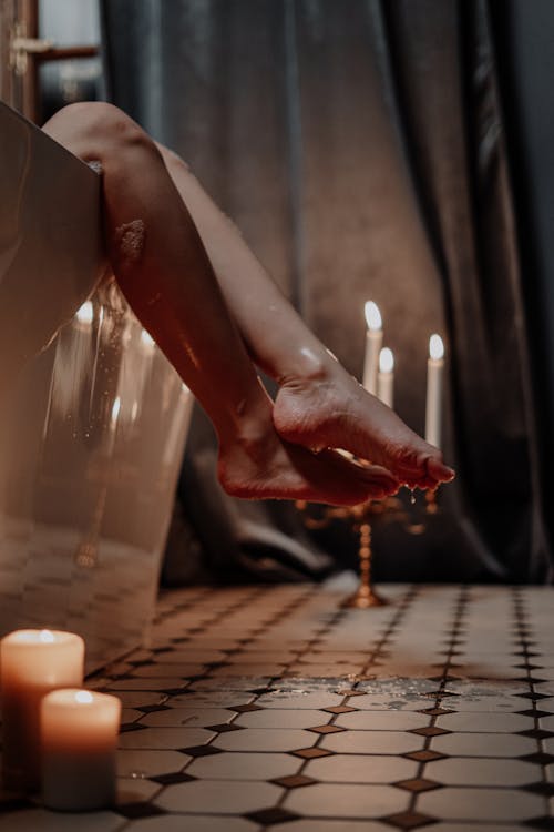 Free Person Holding Lighted Candle on Table Stock Photo