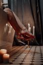 Person Holding Lighted Candle on Table
