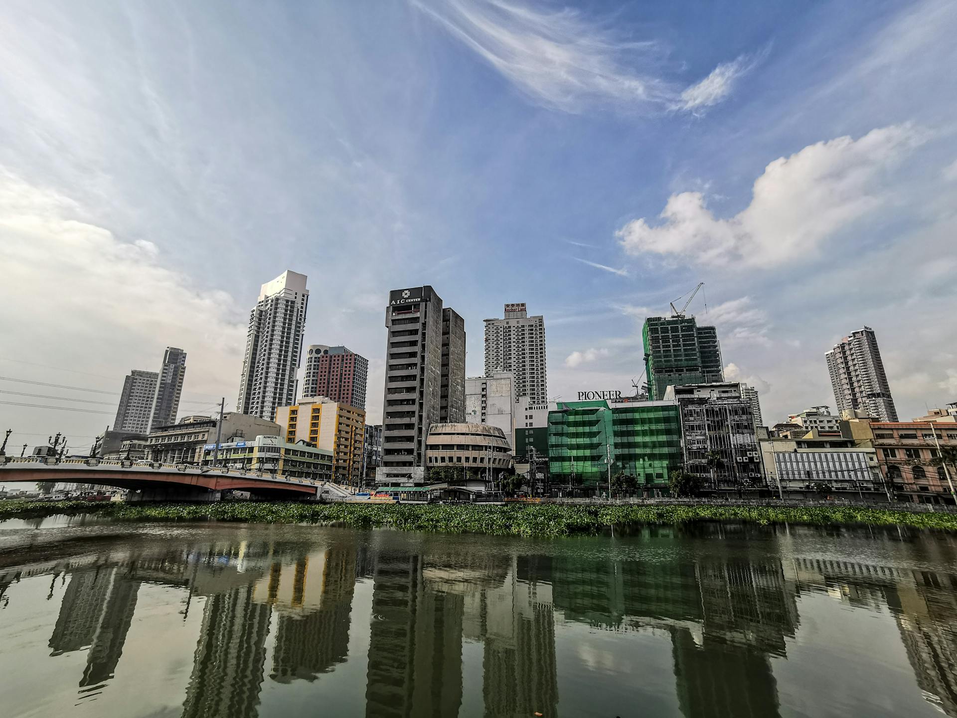 From below of contemporary towers located in office district of big city on Pasig river shore