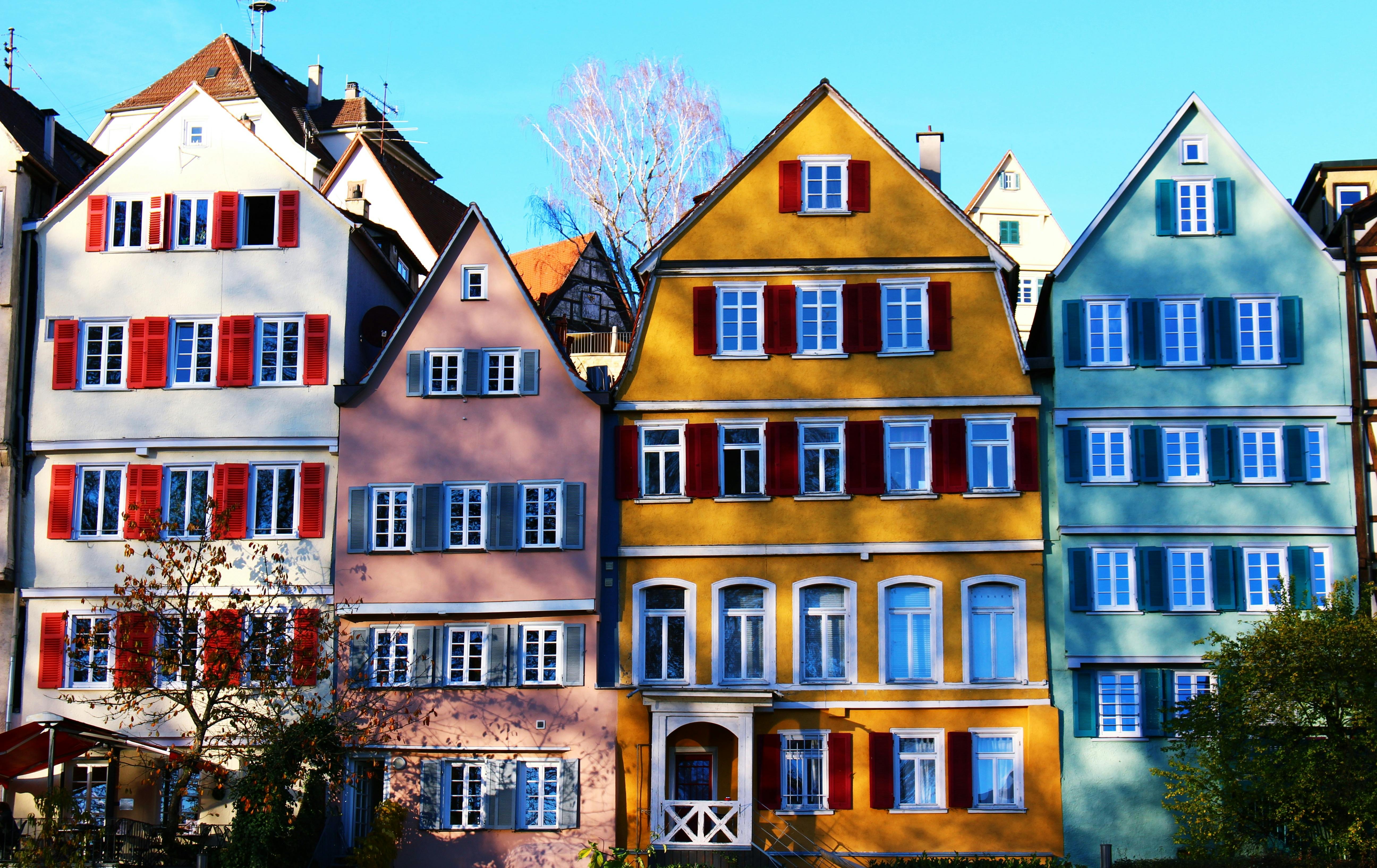 white pink yellow and teal painted houses